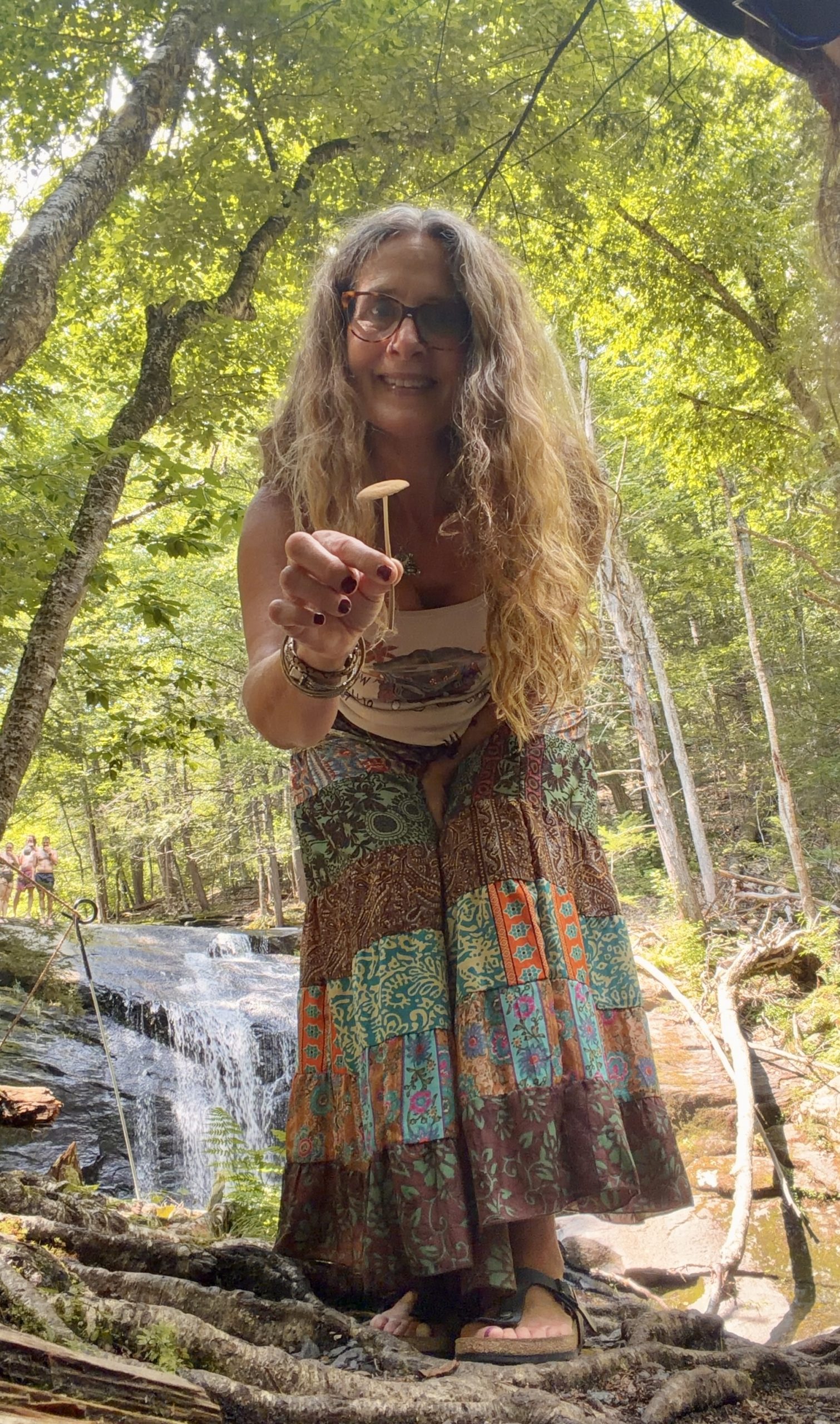 Jill K. Karkella sitting on a park bench, artist and founder of Willow Waves Art